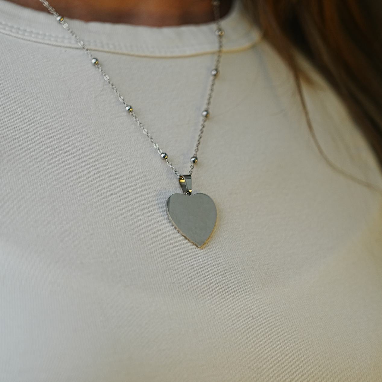 Necklace with a heart-shaped pendant on a plain background